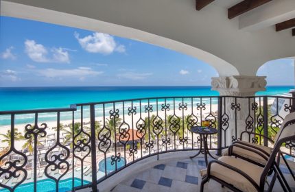 Hyatt Zilara Cancun balcony view. Gay-friendly hotel with ocean view, chairs, and a cocktail. Perfect for LGBTQ+ travelers in Cancun.