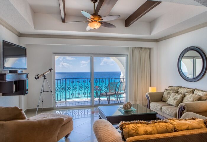 Hyatt Zilara Cancun gay-friendly hotel suite. Ocean view from balcony, telescope, ceiling fan, and comfortable seating area. Luxury travel.