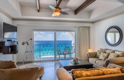 Hyatt Zilara Cancun gay-friendly hotel suite. Ocean view from balcony, telescope, ceiling fan, and comfortable seating area. Luxury travel.