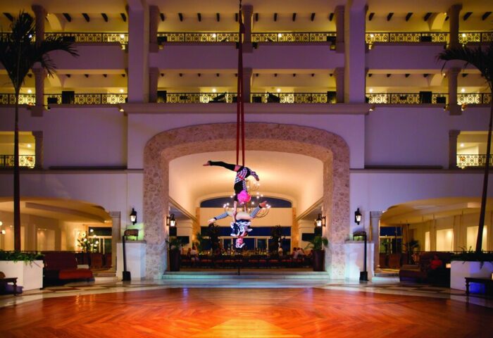 Hyatt Zilara Cancun lobby aerial acrobats. Gay-friendly hotel with entertainment. Cancun luxury resort for gay men travelers.