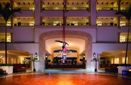 Hyatt Zilara Cancun lobby aerial acrobats. Gay-friendly hotel with entertainment. Cancun luxury resort for gay men travelers.