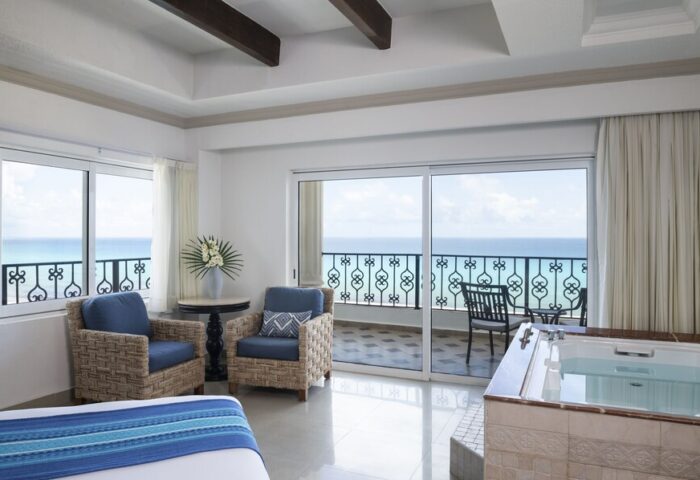 Hyatt Zilara Cancun gay-friendly hotel suite. Ocean view from balcony, jacuzzi tub, seating area. Ideal for gay travel in Cancun.