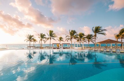 Hyatt Zilara Cancun pool view with palm trees. Gay-friendly hotel in Cancun, Mexico, offers a luxurious and relaxing vacation for gay men.