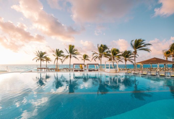 Hyatt Zilara Cancun pool view with palm trees. Gay-friendly hotel in Cancun, Mexico, offers a luxurious and relaxing vacation for gay men.