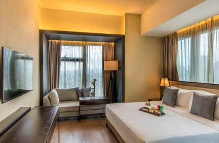 I'M Hotel room. Gay-friendly hotel with modern design. King bed, city view, and sofa. Perfect for gay travel. I'M Hotel, Makati, Philippines.