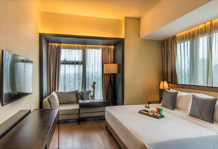 I'M Hotel room. Gay-friendly hotel with modern design. King bed, city view, and sofa. Perfect for gay travel. I'M Hotel, Makati, Philippines.