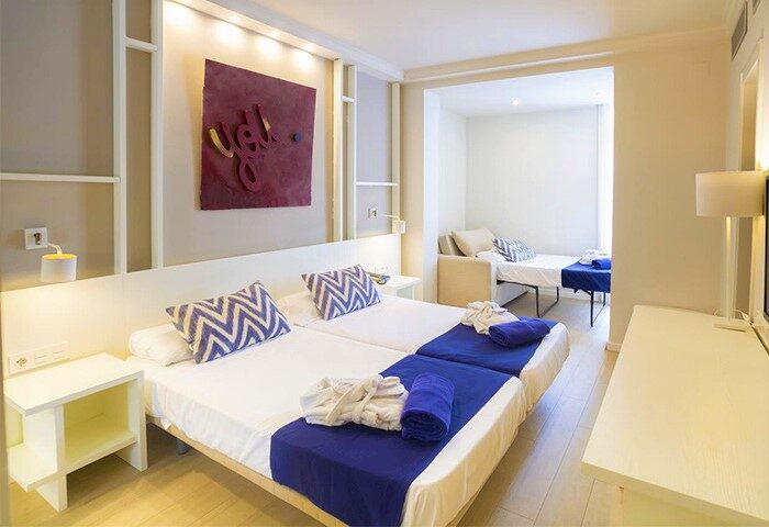 Ibersol Antemare Adults Only gay-friendly hotel room. Modern design with twin beds, blue accents, and a separate seating area.