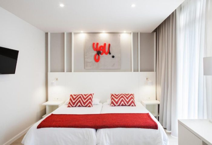 Ibersol Antemare Adults Only gay-friendly hotel room. Modern design, twin beds, red accents, and stylish decor. Perfect for gay travel.