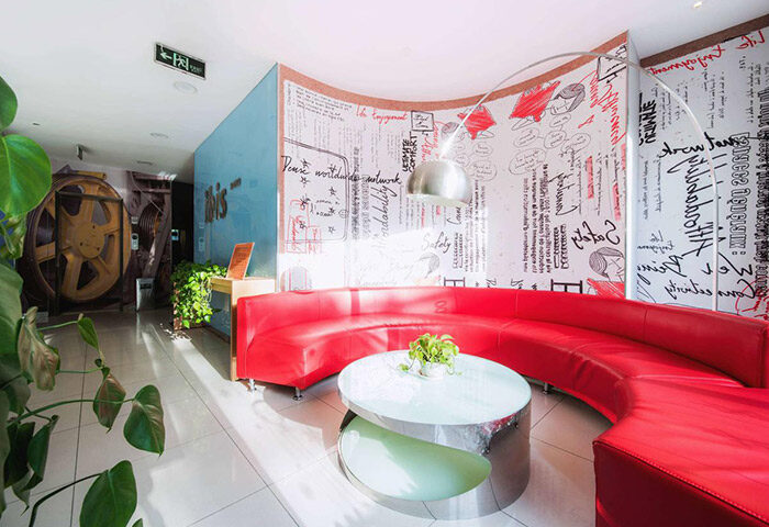 Ibis Beijing Dongdaqiao Hotel lobby with red sofa and unique design. Gay-friendly hotel in Beijing, China for gay men travelers.