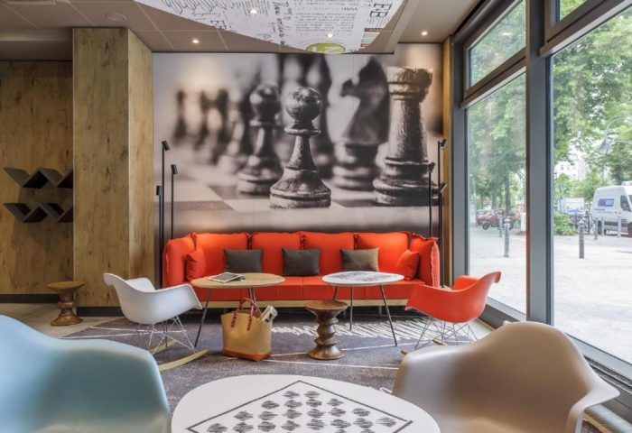 Ibis Berlin Kurfuerstendamm hotel lobby seating area. Chess-themed decor adds a playful touch to this gay-friendly hotel's inviting interior.
