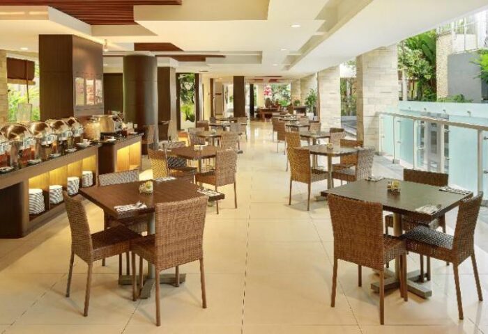 Ibis Budget Bali Seminyak's dining area. Buffet setup, tables, and chairs. Gay-friendly hotel in Seminyak, Bali for gay travelers.