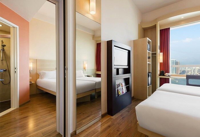 Ibis Hong Kong Central & Sheung Wan Hotel room. Gay-friendly hotel with twin beds, bathroom, city view. Modern design, comfortable stay.
