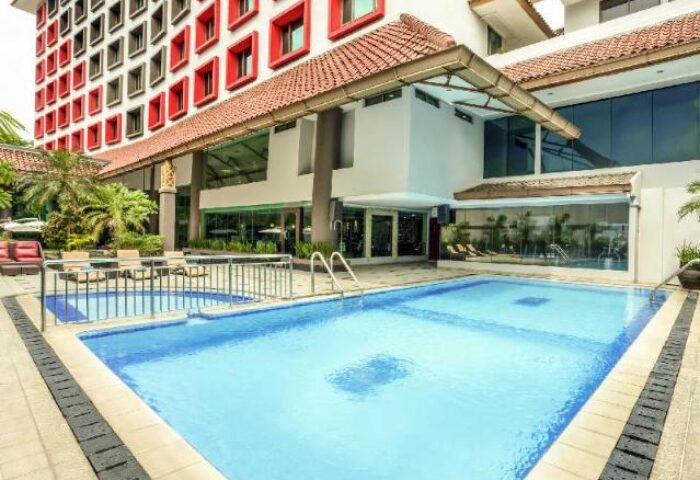 Ibis Jakarta Tamarin Hotel's pool area. A gay-friendly hotel in Jakarta, Indonesia, with a swimming pool for relaxation.