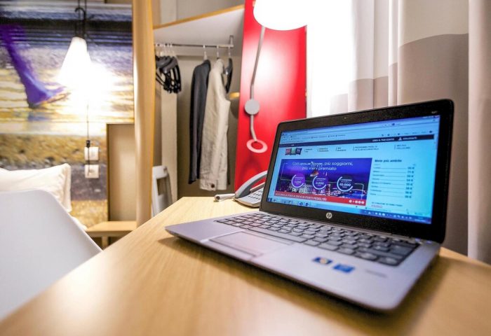 Ibis Milano Centro Hotel room interior. Laptop on desk. Gay-friendly hotel, ideal for gay men travel. Comfortable stay in Milan, Italy.