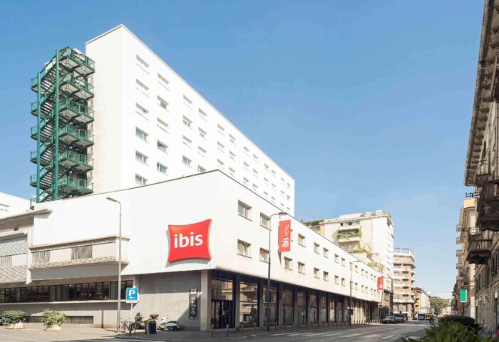 Exterior of Ibis Milano Centro Hotel, a gay-friendly hotel in Milan, Italy. Modern building with Ibis logo. Great for gay travel.