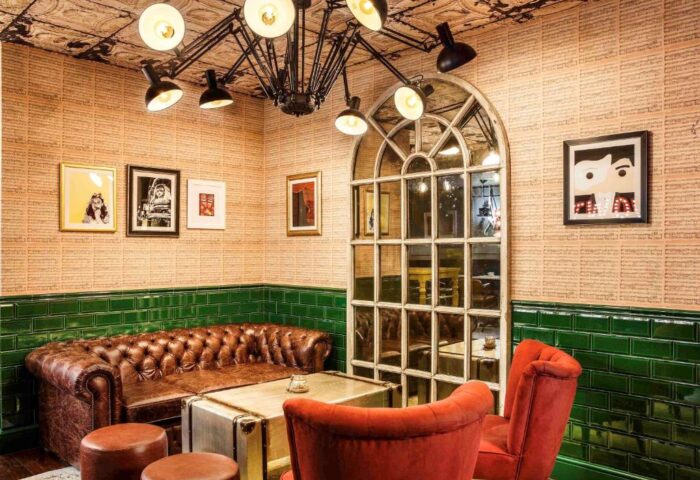 Ibis Styles London Southwark Hotel's lounge area. Gay-friendly hotel with stylish decor, leather sofa, and unique lighting.