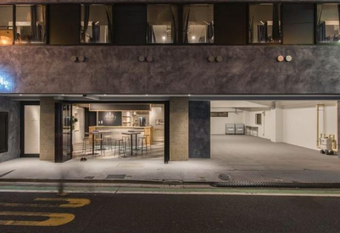 Imano Tokyo Hostel exterior. Gay-friendly hotel with modern design. Open lobby, bar area, and parking. A great choice for gay men traveling in Tokyo.