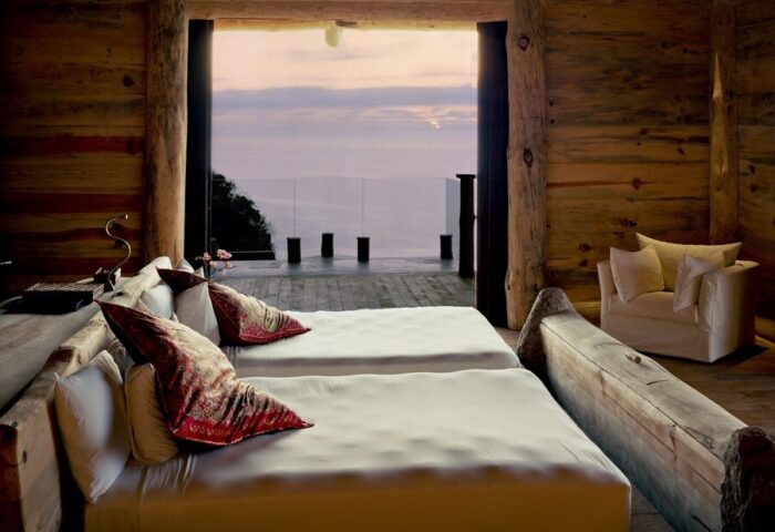 Imanta Resorts Punta De Mita gay-friendly hotel room. Two beds face the ocean view. Rustic wood decor. Luxury gay travel in Mexico.