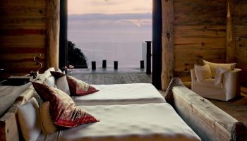 Imanta Resorts Punta De Mita gay-friendly hotel room. Two beds face the ocean view. Rustic wood decor. Luxury gay travel in Mexico.