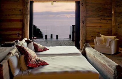 Imanta Resorts Punta De Mita gay-friendly hotel room. Two beds face the ocean view. Rustic wood decor. Luxury gay travel in Mexico.