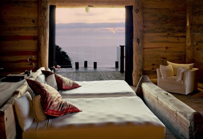Imanta Resorts Punta De Mita gay-friendly hotel room. Two beds face the ocean view. Rustic wood decor. Luxury gay travel in Mexico.