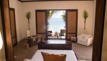 Imanta Resorts Punta De Mita gay-friendly hotel room with ocean view. Luxury travel for gay men in Mexico. Deck chairs on the patio.