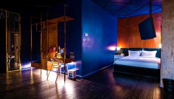 Imperial Palace Boutique Hotel room. Gay-friendly hotel featuring stylish decor, dark wood floors, and a modern, luxurious design.