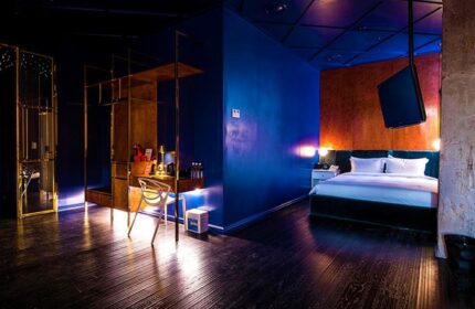 Imperial Palace Boutique Hotel room. Gay-friendly hotel featuring stylish decor, dark wood floors, and a modern, luxurious design.