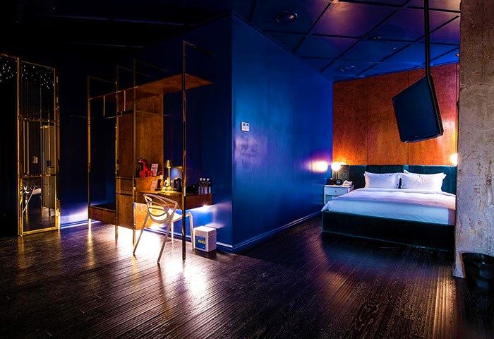 Imperial Palace Boutique Hotel room. Gay-friendly hotel featuring stylish decor, dark wood floors, and a modern, luxurious design.