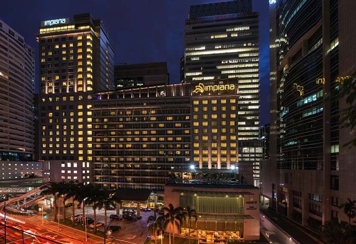 Impiana KLCC Hotel exterior at night. This gay-friendly hotel in Kuala Lumpur offers luxury accommodations near Petronas Towers.