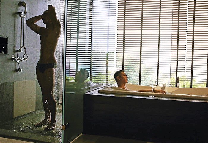 Gay-Friendly Hotel Impiana Private Villas Kata Noi Phuket: Men in shower and bathtub, enjoying luxury travel in Thailand. Modern bathroom.