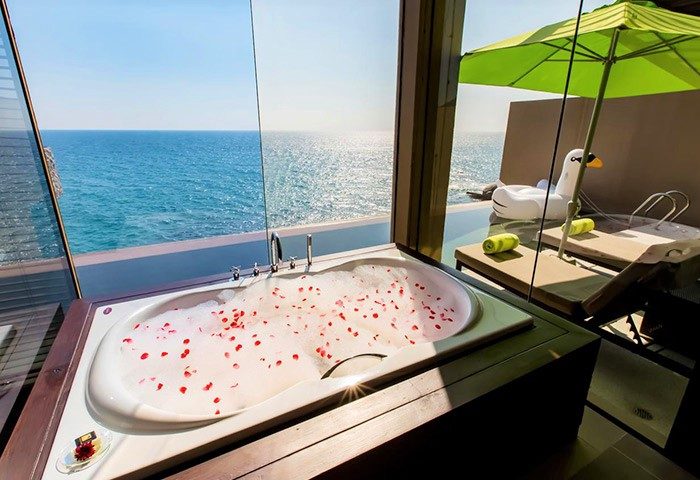 Impiana Private Villas Kata Noi, Phuket: Ocean view from a tub with rose petals. Gay-friendly hotel with luxury amenities. Phuket getaway.