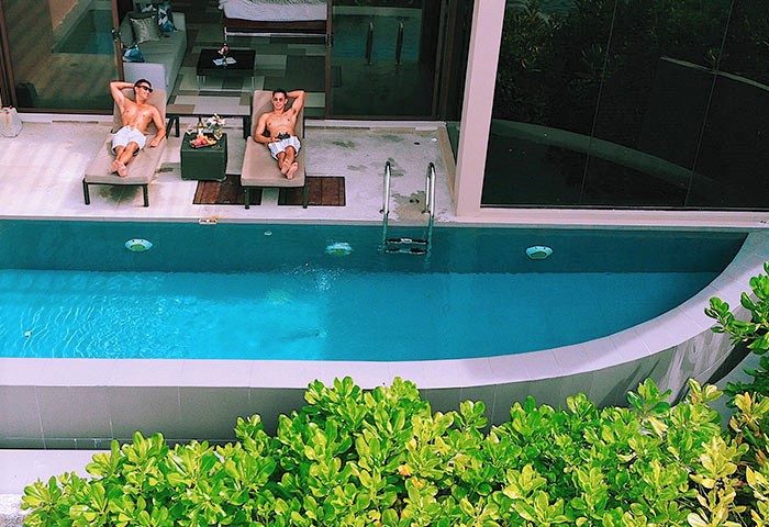 Gay-friendly Impiana Private Villas Kata Noi, Phuket: Two men relax by a private pool at this luxury gay-friendly hotel in Thailand.