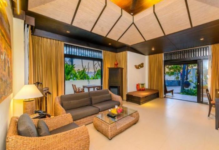 Impiana Resort Patong's gay-friendly hotel suite. Wicker furniture, a daybed, and a view of the beach make it a perfect gay travel destination.