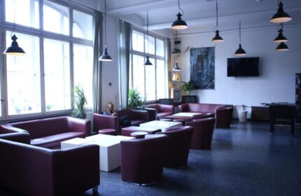 Industriepalast Hostel Berlin lounge area. Gay-friendly hotel with sofas, tables, and a relaxed atmosphere. Great for gay travelers in Berlin.