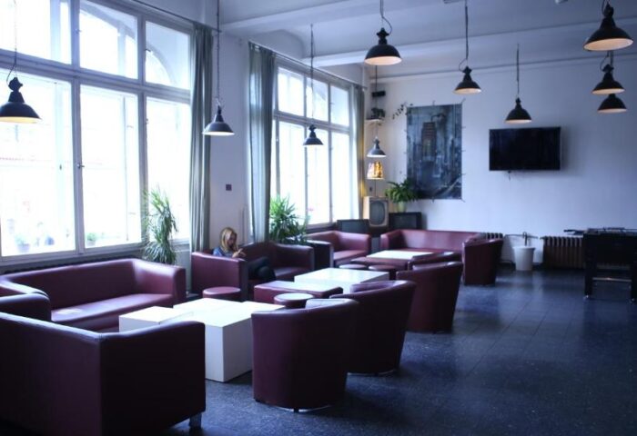 Industriepalast Hostel Berlin lounge area. Gay-friendly hotel with sofas, tables, and a relaxed atmosphere. Great for gay travelers in Berlin.