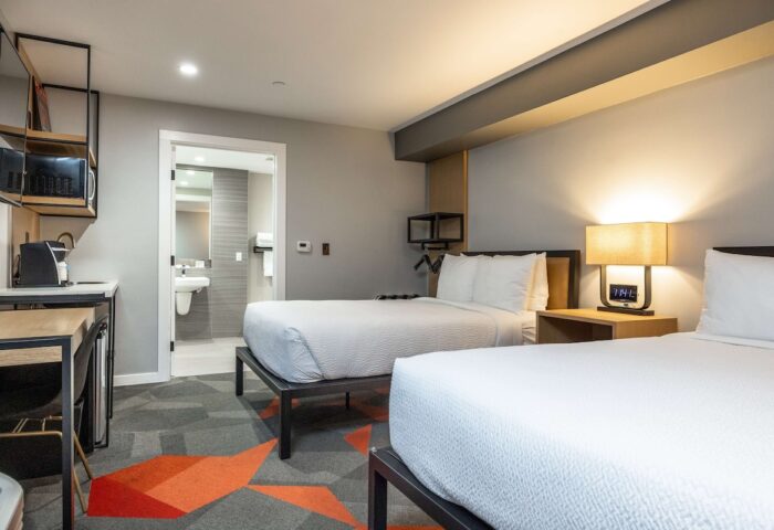 Infinity Hotel San Francisco, Tapestry Collection by Hilton guest room. Two beds, bathroom, desk, microwave. Gay-friendly hotel.