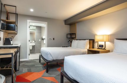 Infinity Hotel San Francisco, Tapestry Collection by Hilton guest room. Two beds, bathroom, desk, microwave. Gay-friendly hotel.