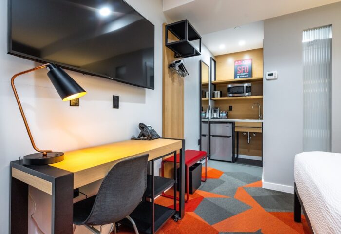 Infinity Hotel San Francisco, a Tapestry Collection by Hilton. Gay-friendly hotel room with desk, TV, and kitchenette. Modern design.