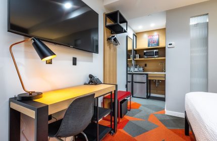 Infinity Hotel San Francisco, a Tapestry Collection by Hilton. Gay-friendly hotel room with desk, TV, and kitchenette. Modern design.