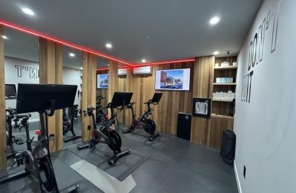 Infinity Hotel San Francisco gym. Tapestry Collection by Hilton, a gay-friendly hotel. Exercise bikes, towels, and motivation.