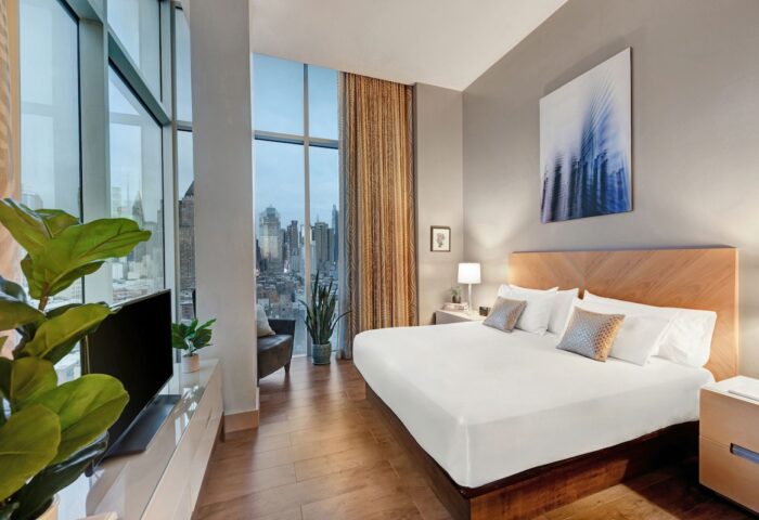 Ink 48 Hotel room with city view. Gay-friendly hotel featuring modern design, king bed, and floor-to-ceiling windows. Upscale lodging for gay travelers.