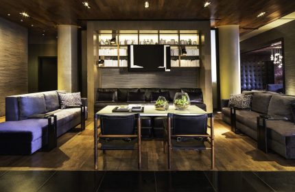 Ink 48 Hotel's gay-friendly interior. Stylish lounge area with sofas, chairs, and a modern design. A welcoming space for gay travelers.