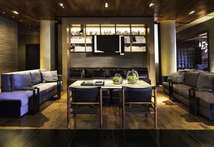 Ink 48 Hotel's gay-friendly interior. Stylish lounge area with sofas, chairs, and a modern design. A welcoming space for gay travelers.