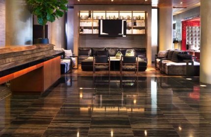 Ink 48 Hotel lobby interior. Gay-friendly hotel features stylish seating areas, modern design, and a welcoming atmosphere for LGBTQ+ travelers.