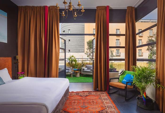 Inta Hotel, Tel Aviv-Jaffa. Gay-friendly adults-only room with balcony, seating area, plants, and view. Ideal for gay travelers.