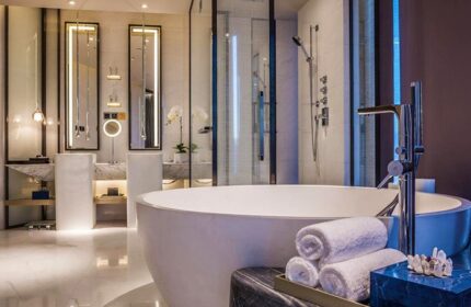 InterContinental Beijing Sanlitun gay-friendly hotel bathroom. Modern design with a large tub, towels, and sleek fixtures. Luxury travel.