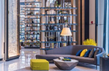 InterContinental Beijing Sanlitun lobby lounge. Gay-friendly hotel with modern design, bookshelves, sofa, and stylish decor. Upscale travel.