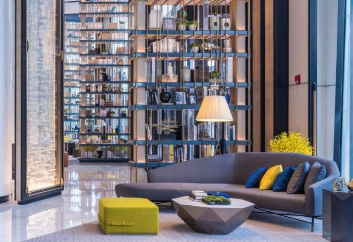 InterContinental Beijing Sanlitun lobby lounge. Gay-friendly hotel with modern design, bookshelves, sofa, and stylish decor. Upscale travel.