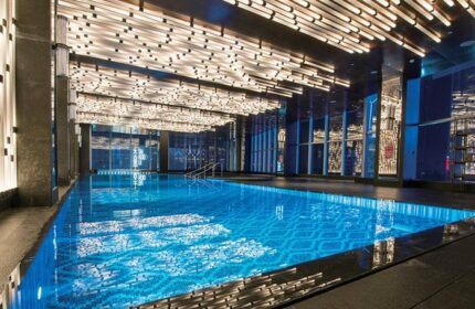 Indoor pool at the gay-friendly InterContinental Beijing Sanlitun hotel. Modern design with blue mosaic tiles and unique lighting.